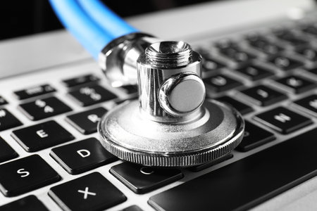 Technical support concept. Stethoscope on laptop keyboard, closeupの写真素材
