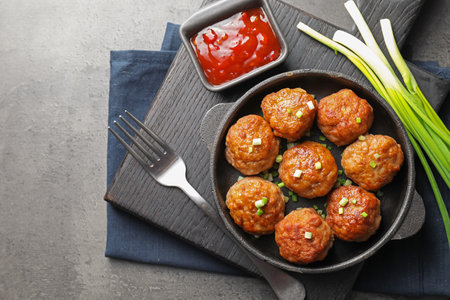 Tasty meatballs served on gray table, flat layの写真素材