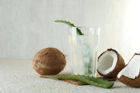 Refreshing drink with coconut and aloe on white textured table. Space for textの写真素材