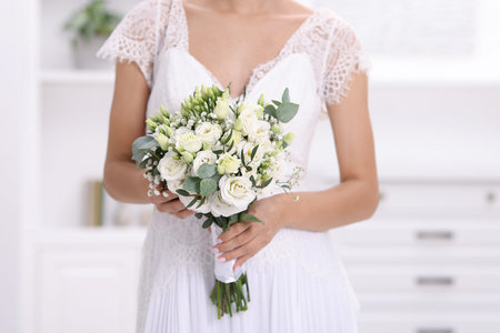 Bride with beautiful wedding bouquet on light background, closeupのeditorial素材