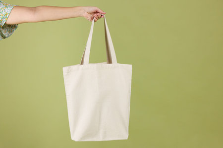 Woman with blank shopper bag on color background, closeup. Mockup for design
