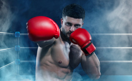 Boxer training on boxing ring in color smokeの写真素材