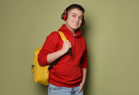 Teenage boy with headphones and backpackの写真素材