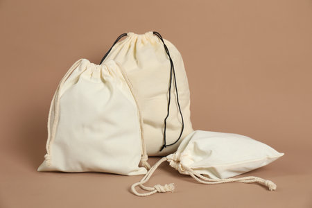 Different cotton bags on dark beige backgroundの写真素材
