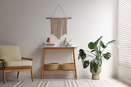 Stylish room interior with console table near white wallの写真素材