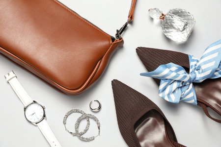 Flat lay composition with jewelry, accessories and shoes on light grey backgroundの写真素材