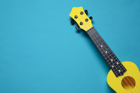 One ukulele on light blue background, top view. Space for textの写真素材