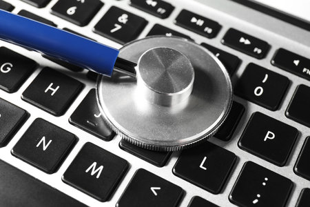 Technical support concept. Stethoscope on laptop keyboard, closeupの写真素材