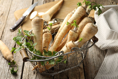 Raw parsley roots with leaves on wooden tableの写真素材