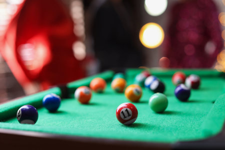 Many colorful billiard balls on green table indoors, closeup. Space for textの写真素材