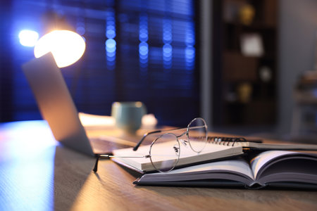 Workspace with laptop on wooden desk in home office, selective focus. Space for textの写真素材