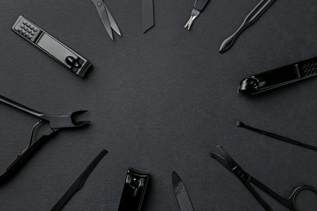 Set of pedicure tools on black background, flat lay. Space for textの写真素材