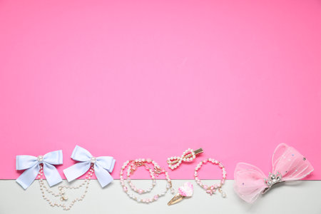 Different hair accessories, necklace and bracelet on color background, flat lay. Space for textの写真素材