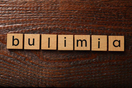 Squares with word Bulimia on wooden table, flat layの写真素材