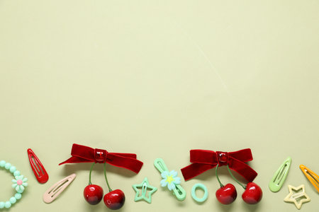 Different hair accessories on light green background, flat lay. Space for textの写真素材