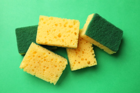 Soft sponges on green background, top view. Cleaning toolの写真素材