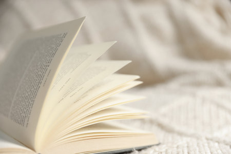 Open book on blanket, closeup. Space for textの写真素材