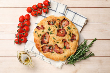 Delicious focaccia bread with bacon and parsley on white wooden table, flat layの写真素材