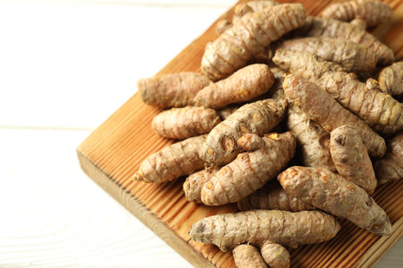 Raw tumeric rhizomes on white table, closeupの写真素材