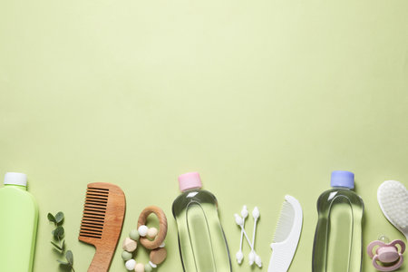 Baby oil and bath accessories on light background, flat lay. Space for textの写真素材