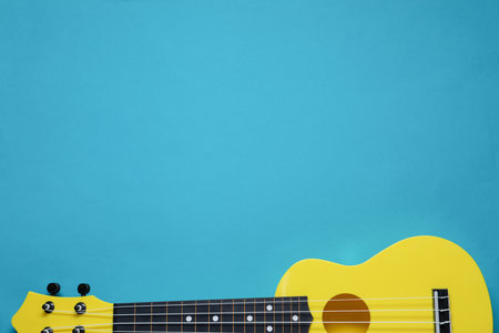 One ukulele on light blue background, top view. Space for textの写真素材