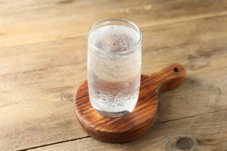 Refreshing soda water in glass on wooden table, closeupの写真素材