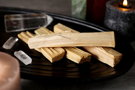 Palo santo sticks, gemstones and burning candles on grey table, closeupの写真素材