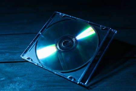 One compact disc in jewel case on wooden background, closeupの写真素材