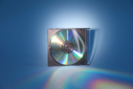 One compact disc in jewel case on light blue backgroundの写真素材