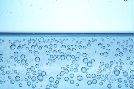 Refreshing soda water in glass against light background, closeup