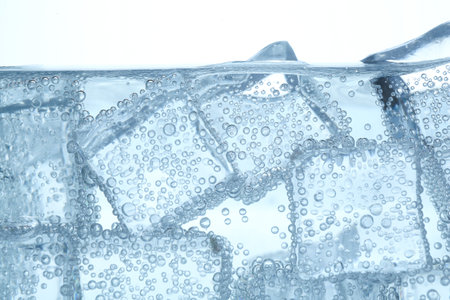 Refreshing soda water with ice cubes against white background, closeupの写真素材