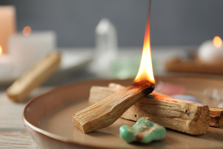 Burning palo santo stick and gemstone on table, closeupの写真素材
