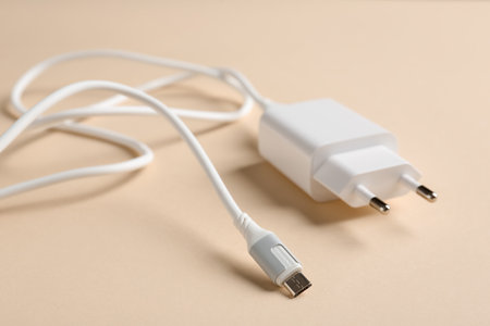 USB power adapter with charge cable on beige background, closeupの写真素材