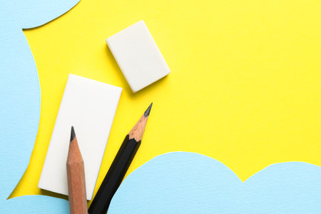Erasers and pencils on color background, flat lay. Space for textの写真素材