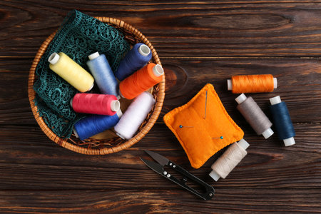 Different sewing supplies on wooden background, flat layの写真素材