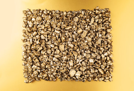 Gold nuggets on shiny background, top viewの写真素材