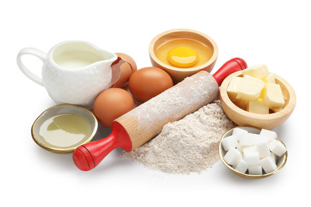 Rolling pin and different ingredients isolated on whiteの写真素材