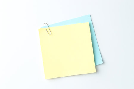 Paper notes with clip on light background, top viewの写真素材