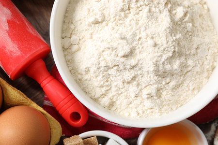 Rolling pin and ingredients for dough on table, flat layの写真素材
