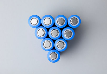 Many AA cell batteries on light grey background, top viewの写真素材