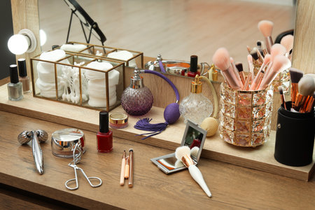 Makeup room. Different beauty products on wooden dressing table indoorsの写真素材