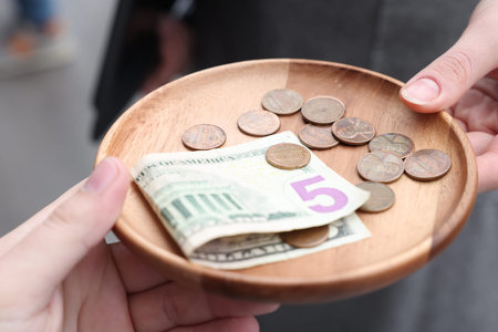 Client giving tips to waitress in outdoor cafe, closeup