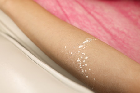 Woman with moisturizing lotion on her arm after depilation procedure in beauty salon, closeupの写真素材