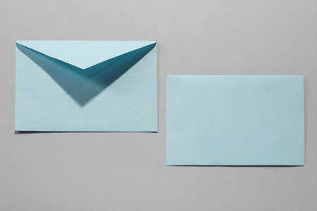Paper envelopes on grey background, above view. Mockup for designの写真素材