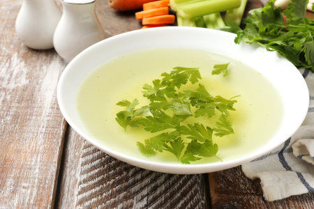 Tasty chicken bouillon served on wooden table, closeupの写真素材