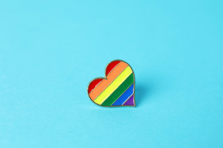 Heart shaped badge in LGBT colors on light blue backgroundの写真素材