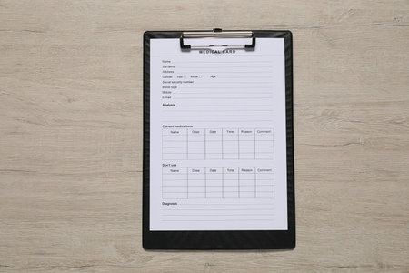 Medical card form on light wooden background, top viewの写真素材