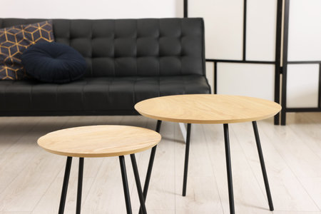 Nesting tables and comfortable sofa in room. Interior designの写真素材