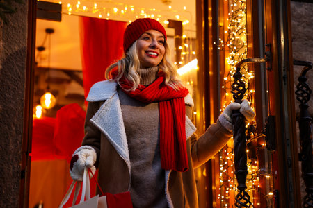 Happy woman with shopping bags near shop outdoors. Christmas seasonの写真素材