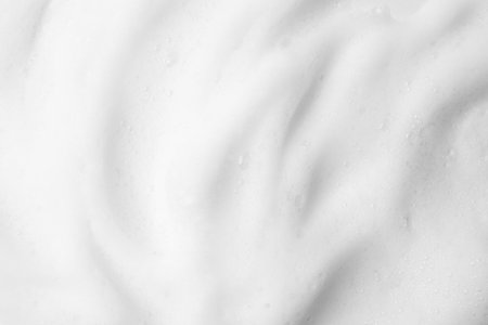 White fluffy foam as background, top viewの写真素材